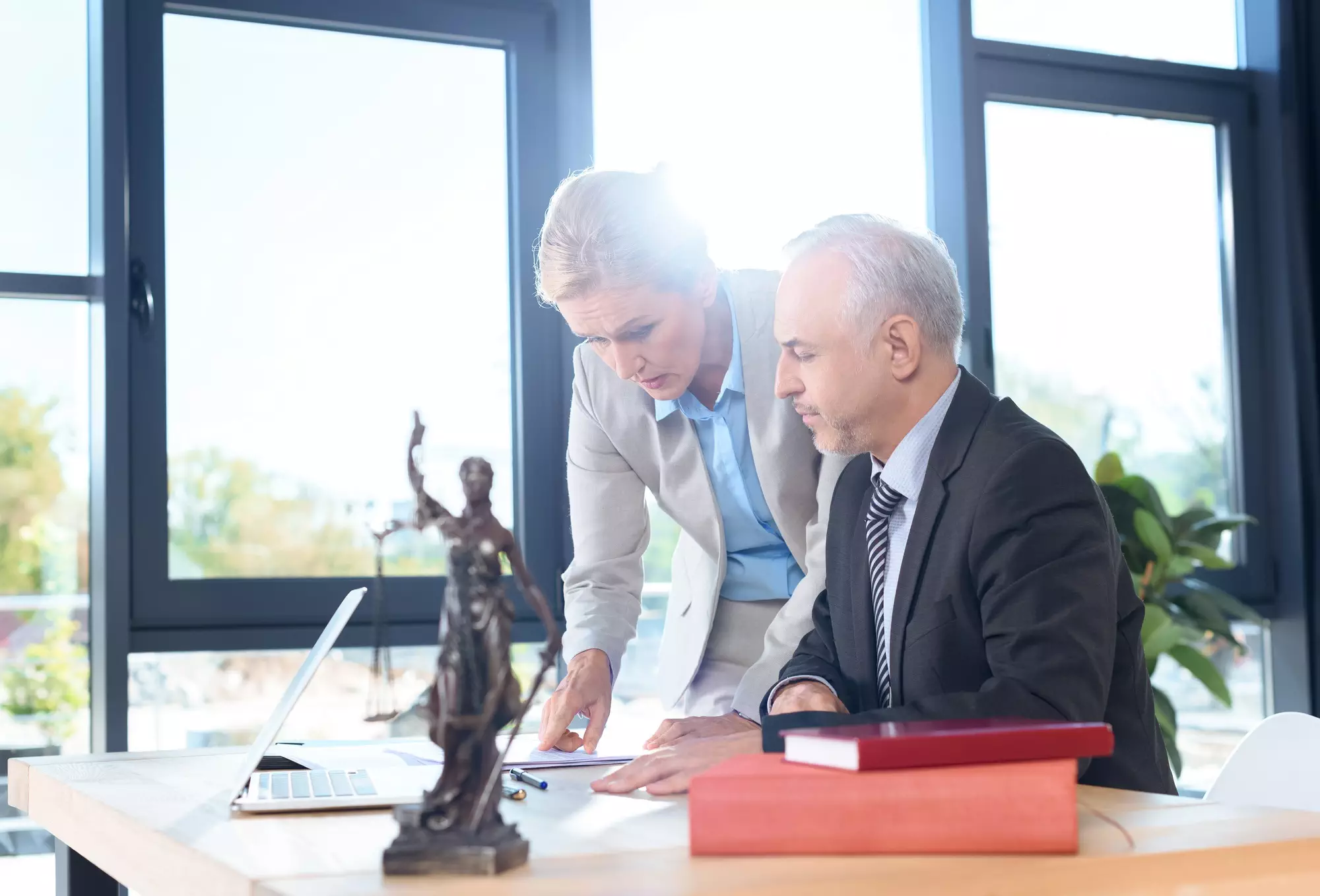 Parents Face Neglect Allegations: How a Messy Floor Sparked a MA DCF Investigation 8 mature lawyers discussing plans at modern workplace-parents