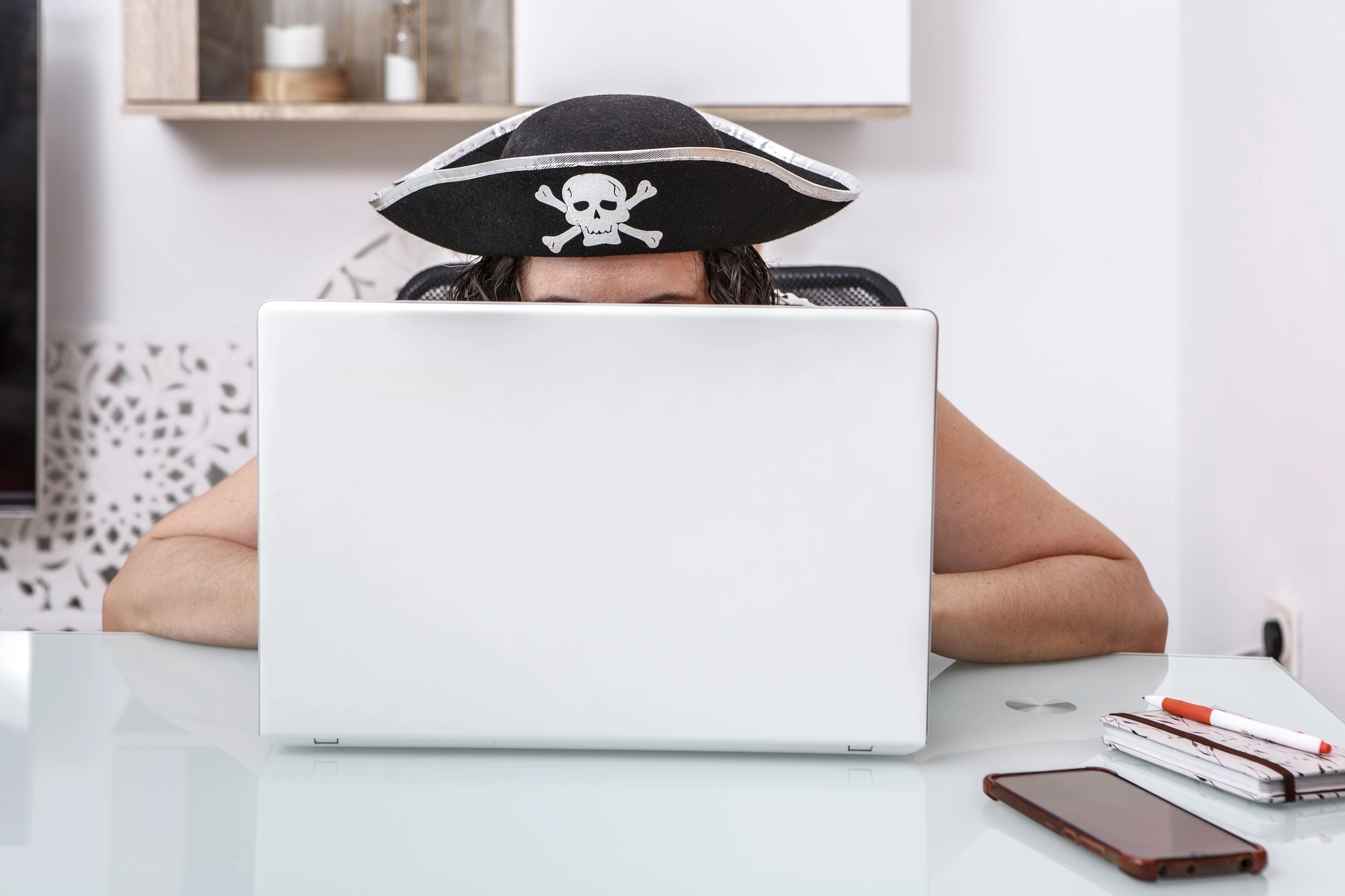 Watch Out for These 4 Common Scams: How to Stay Ahead of Scammers 6 Pirate-Themed Hacker Engaging in Online Scams at a Modern Home Office